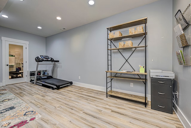 workout room featuring light hardwood / wood-style flooring