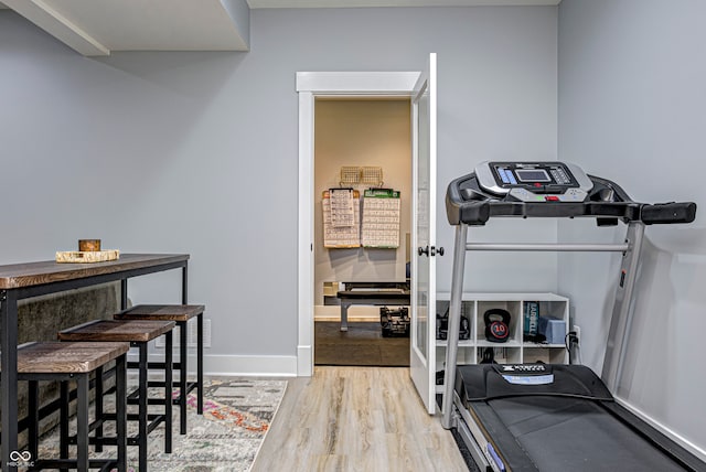 workout room featuring light hardwood / wood-style flooring