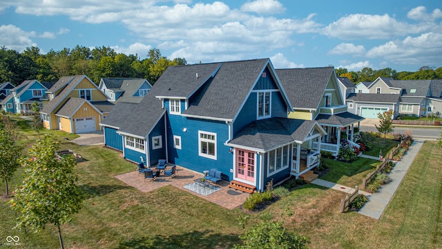 rear view of house featuring a yard and a patio