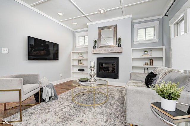 living room featuring ornamental molding, wood-type flooring, and plenty of natural light