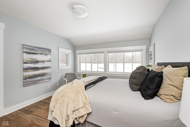 bedroom with dark wood-type flooring and vaulted ceiling