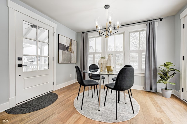 dining room with plenty of natural light, a chandelier, and light hardwood / wood-style flooring