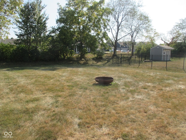 view of yard with an outbuilding and a fire pit