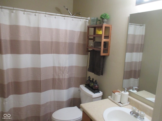 bathroom with vanity, toilet, and a shower with shower curtain