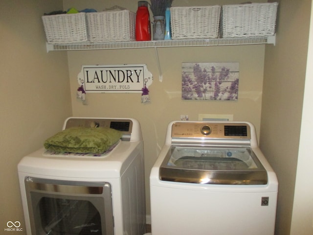 clothes washing area with washer and clothes dryer