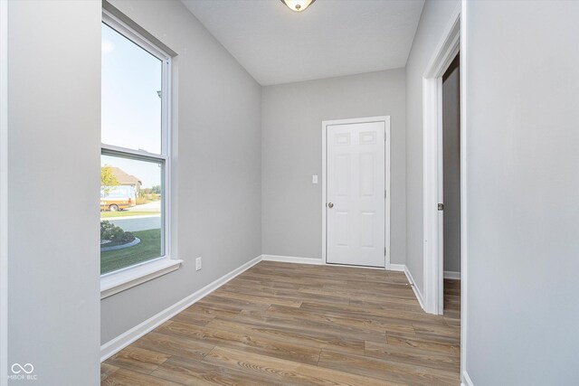 unfurnished room with wood-type flooring