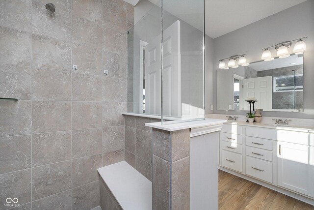 bathroom featuring vanity, hardwood / wood-style floors, and walk in shower