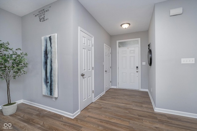 interior space with baseboards and wood finished floors