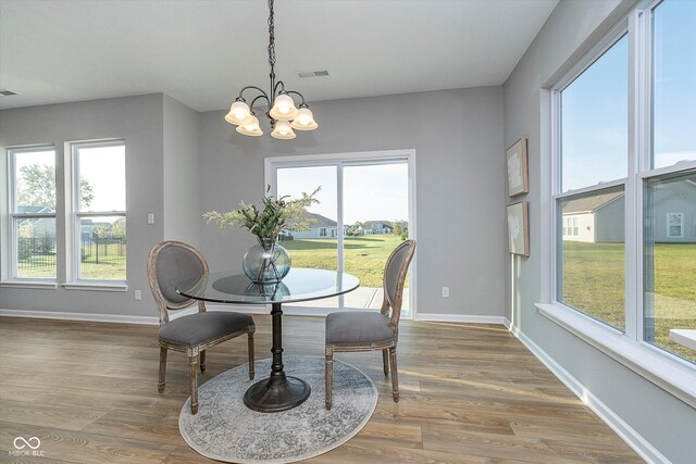 dining room with wood-type flooring and a chandelier