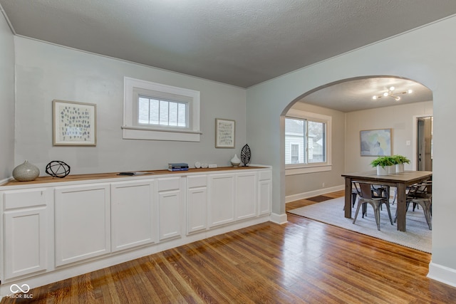 dining area featuring a textured ceiling and light hardwood / wood-style floors