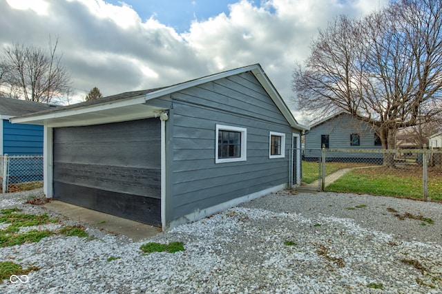 view of side of home featuring an outbuilding and a garage