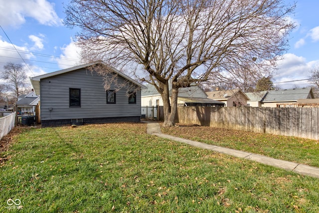 rear view of property featuring a yard