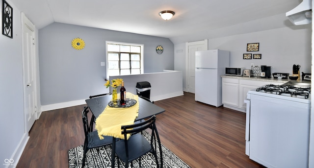 interior space with vaulted ceiling and dark hardwood / wood-style flooring