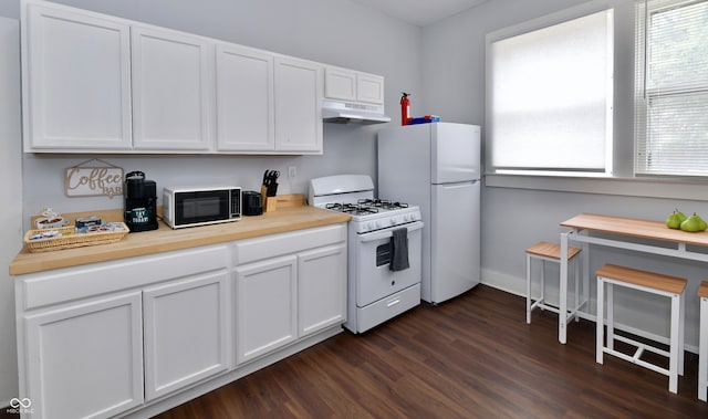 kitchen featuring dark wood-type flooring, white appliances, and white cabinetry