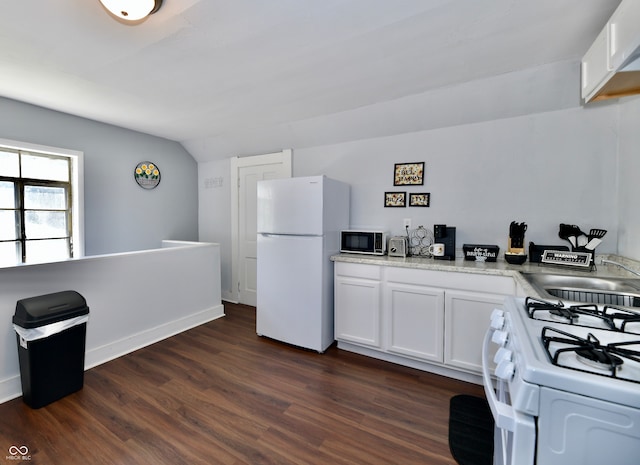 kitchen with white appliances, dark hardwood / wood-style flooring, white cabinetry, and vaulted ceiling