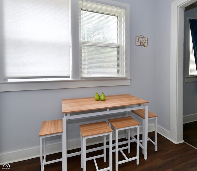 dining area with dark wood-type flooring, breakfast area, and plenty of natural light