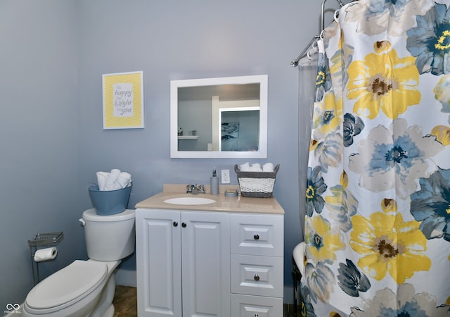 bathroom with walk in shower, toilet, and vanity