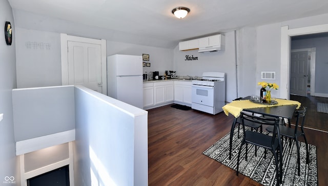 kitchen with white cabinetry, white appliances, extractor fan, and dark hardwood / wood-style floors