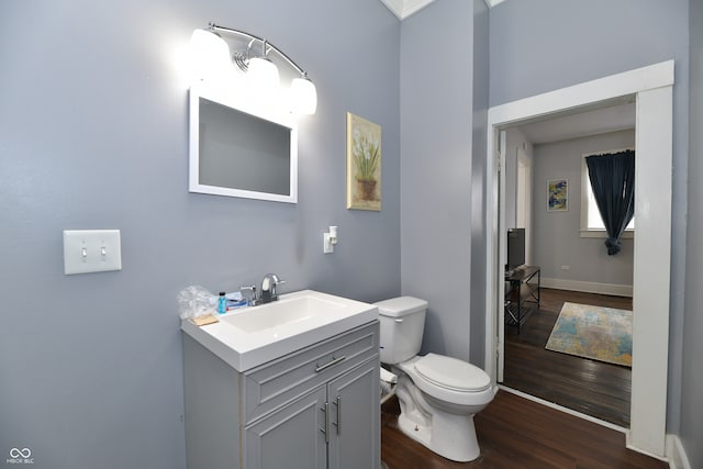 bathroom with vanity, toilet, and wood-type flooring