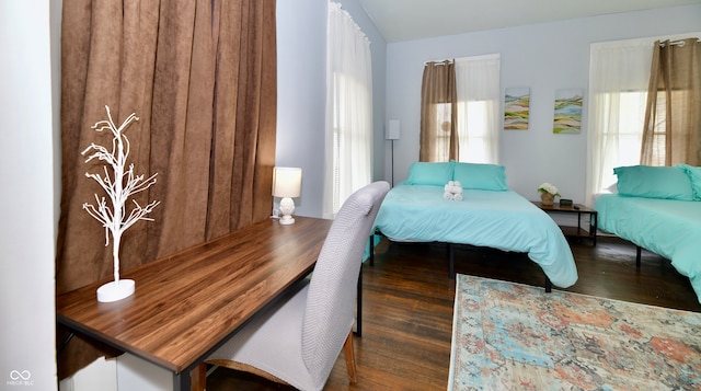 bedroom with multiple windows and dark hardwood / wood-style flooring