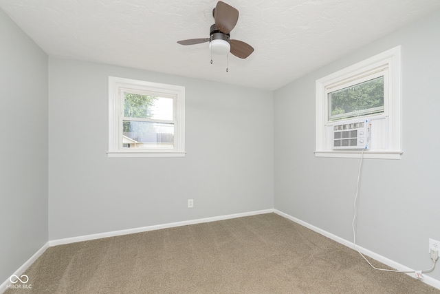 spare room with cooling unit, ceiling fan, and carpet floors