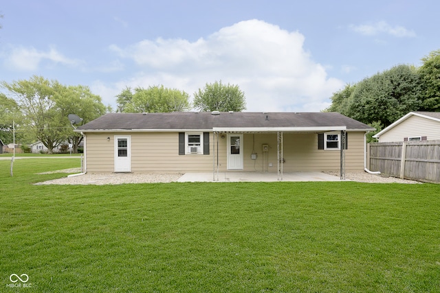 back of property with a yard and a patio area