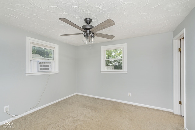 unfurnished room featuring light carpet, ceiling fan, and a wealth of natural light