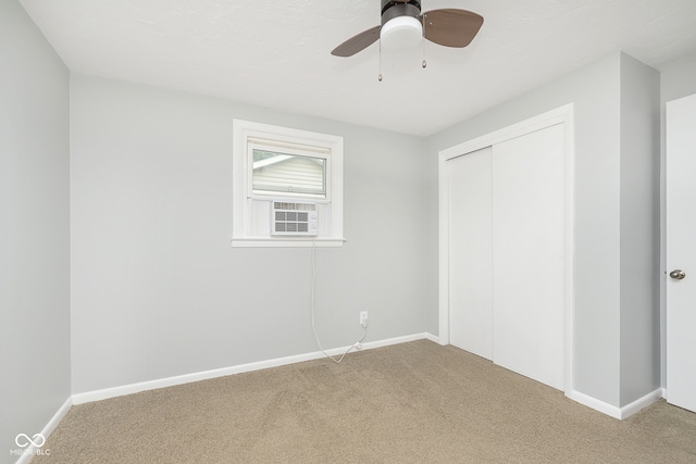 unfurnished bedroom with a closet, ceiling fan, and carpet floors