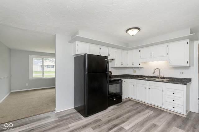 kitchen with white cabinets, light hardwood / wood-style flooring, sink, and black appliances