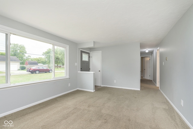 unfurnished room with light colored carpet