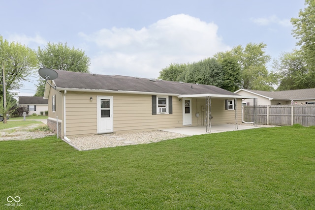 rear view of property with a lawn and a patio area