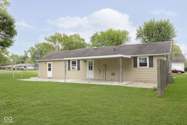 rear view of property featuring a patio area and a yard