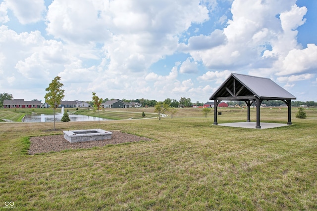 view of property's community featuring a gazebo, a water view, and a lawn