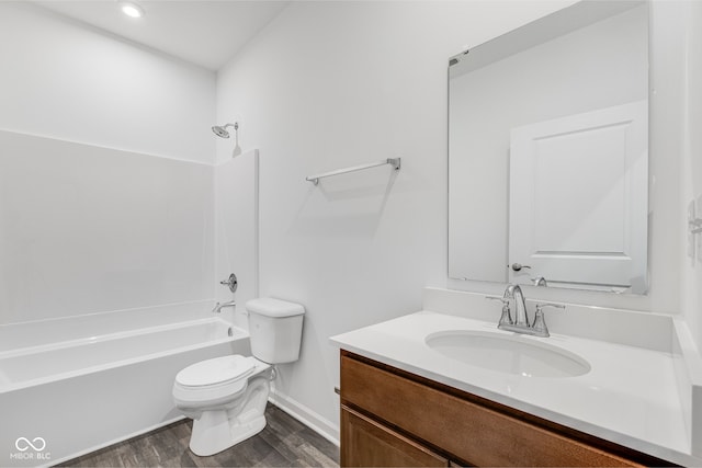 full bathroom featuring shower / bathing tub combination, hardwood / wood-style floors, vanity, and toilet