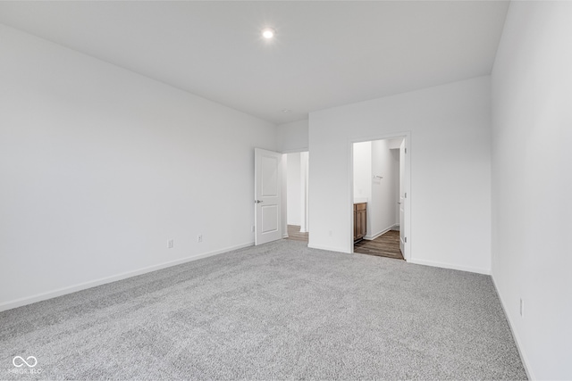 unfurnished bedroom featuring connected bathroom and carpet floors