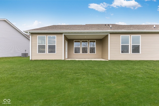 back of house featuring central air condition unit, a patio area, and a lawn