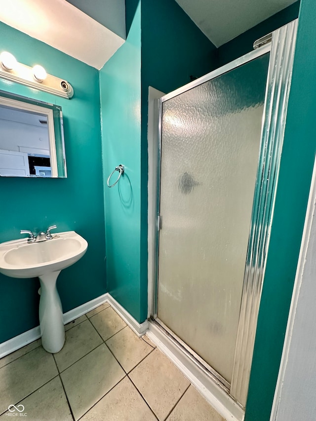 bathroom with tile patterned flooring, sink, and walk in shower