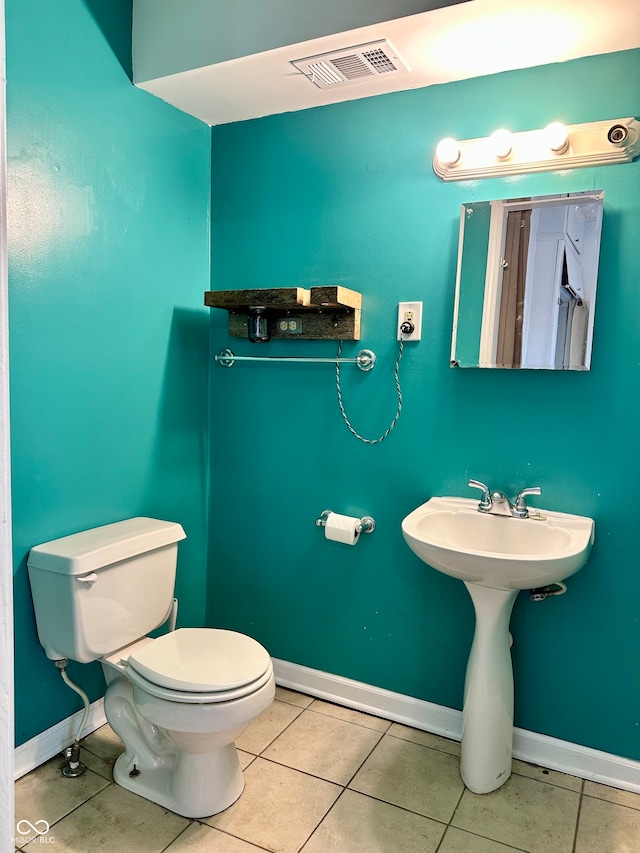 bathroom featuring tile patterned floors and toilet