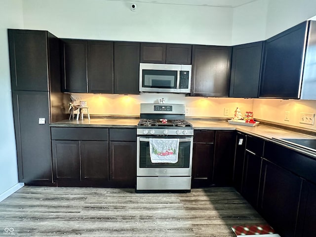 kitchen with sink, light hardwood / wood-style floors, and appliances with stainless steel finishes