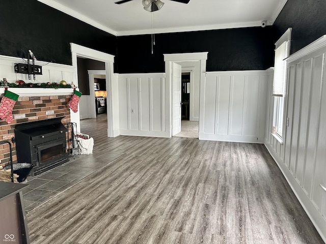 unfurnished living room featuring hardwood / wood-style floors, ceiling fan, and crown molding