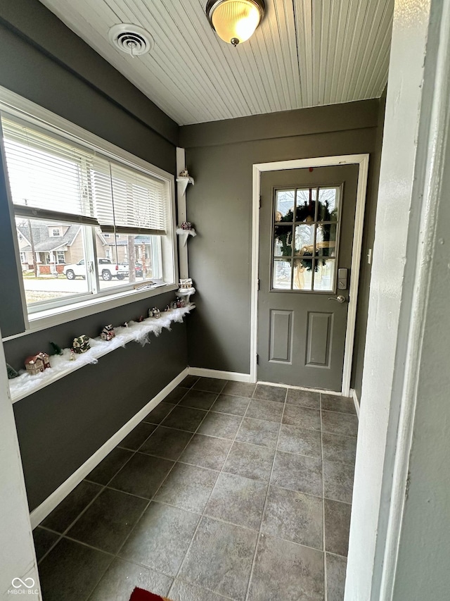 interior space with tile patterned flooring, plenty of natural light, and wood ceiling