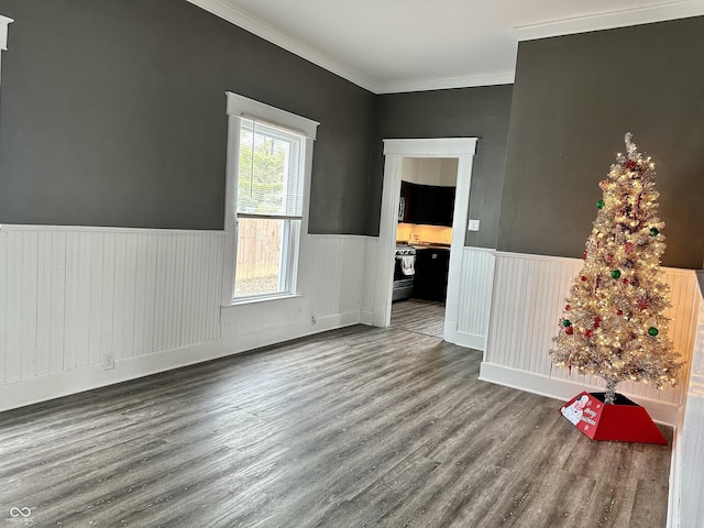 spare room with hardwood / wood-style floors and crown molding