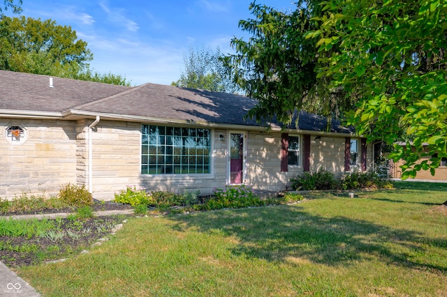 ranch-style home with a front lawn