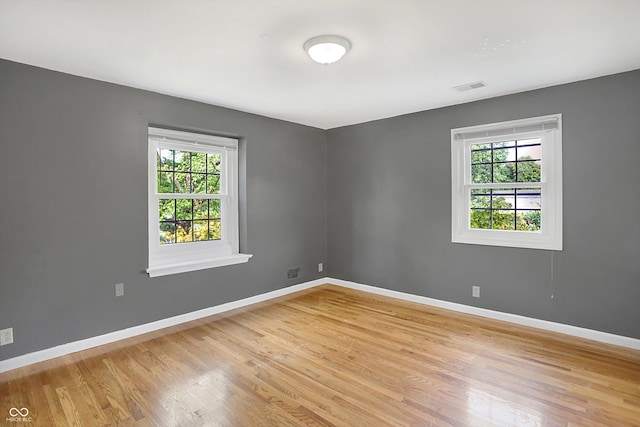 spare room with a healthy amount of sunlight and light hardwood / wood-style flooring