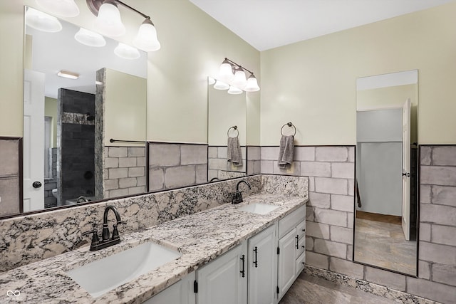 bathroom featuring vanity, toilet, and a shower