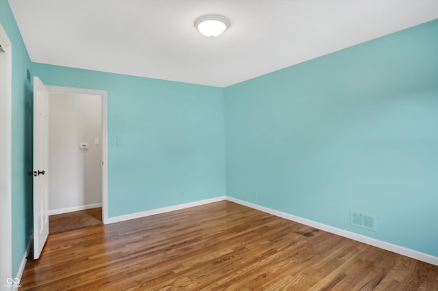 spare room featuring hardwood / wood-style flooring