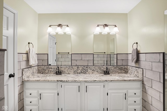 bathroom with vanity and decorative backsplash