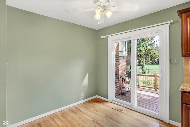 doorway to outside with ceiling fan and light wood-type flooring