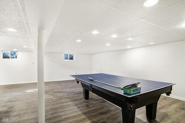 game room with dark wood-type flooring and a paneled ceiling