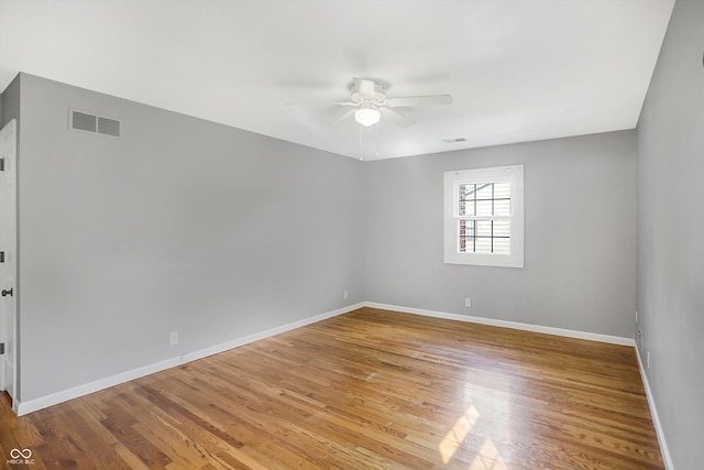 spare room with ceiling fan and hardwood / wood-style flooring